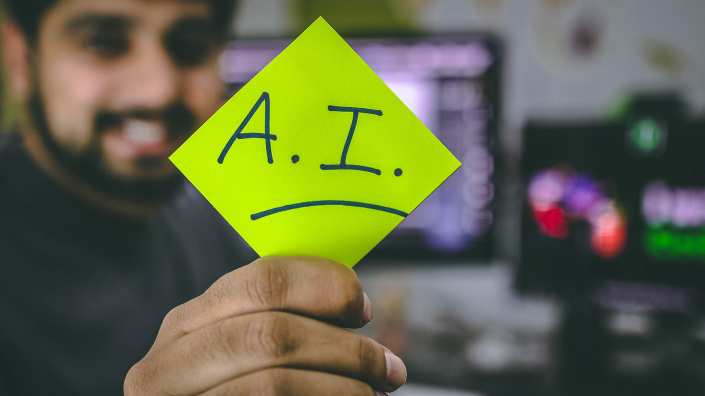 Man holding a post it that says A.I.