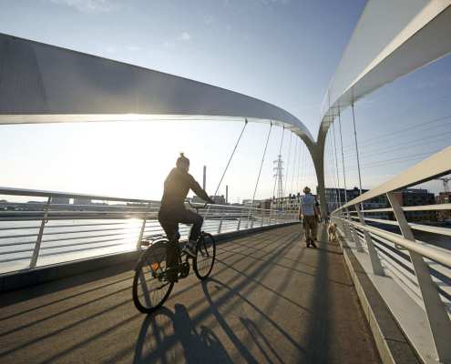 Cyclist on Grandpa's Bridge in Helsinki Kalasatama